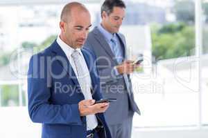 Business colleagues using phones