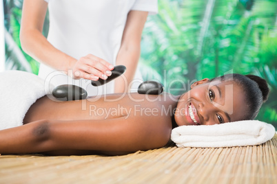 Smiling woman enjoying a hot stone massage