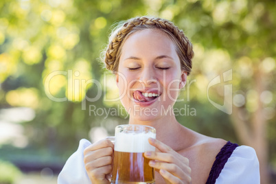 Pretty oktoberfest blonde drinking in the park