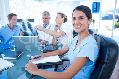 Team of doctors working on laptop and analyzing xray