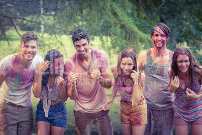 Happy friends covered in powder paint