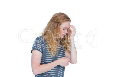 Woman with headache pinching her nose
