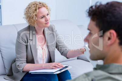 Businesswoman giving paper tissue to her colleague