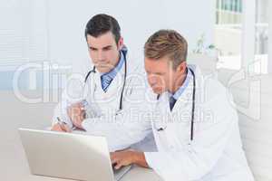 Concentrated doctors working with computer