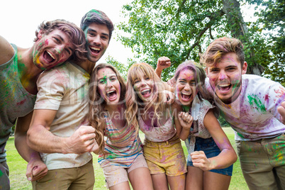 Happy friends throwing powder paint