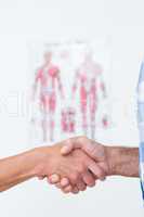 Patient shaking hands with doctor