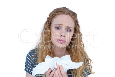 Sick blonde woman holding paper tissue