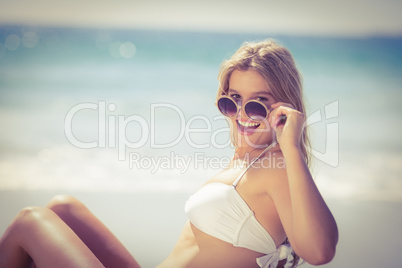 Smiling pretty blonde wearing sun glasses and looking at camera