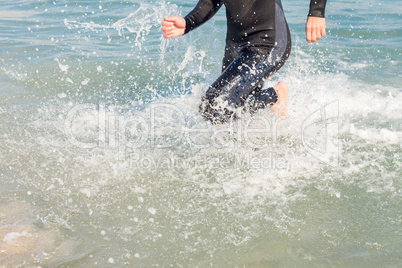 Swimmer running in the ocean