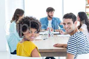 Smiling students at the table