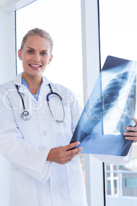 Smiling female doctor looking at Xray