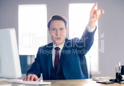 Angry businessman pointing and shouting