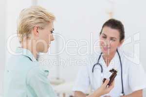 Patient looking at medication with her doctor