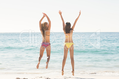 Happy friends jumping together