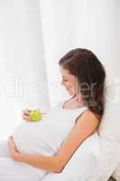 Happy pregnancy with an apple on his belly