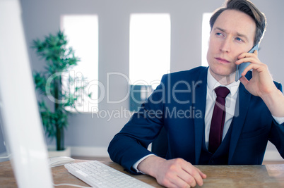 Serious businessman having a phone call