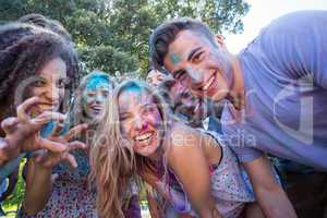 Happy friends covered in powder paint