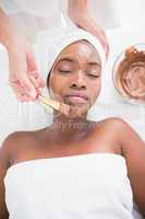 Pretty woman getting a chocolate facial treatment