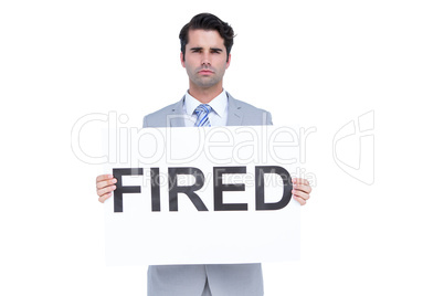 Sad businessman holding a fired sign