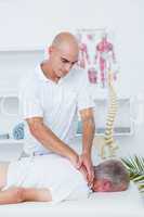 Physiotherapist doing neck massage to his patient