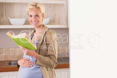 Blonde pregnancy smiling at camera and take a book