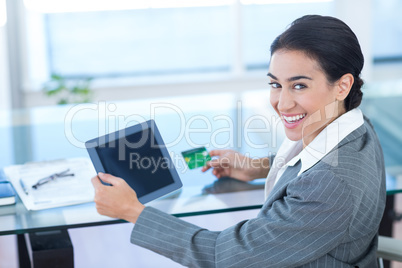 Businesswoman doing online shopping in office