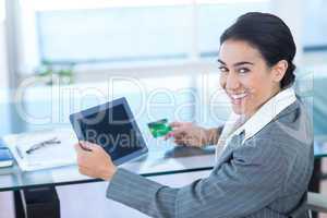 Businesswoman doing online shopping in office