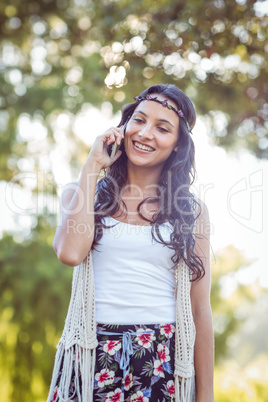 Pretty hipster on the phone in the park