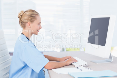 Smiling nurse using computer