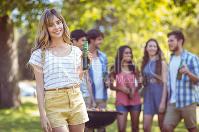 Happy friends in the park having barbecue