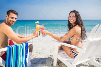 Happy couple drinking a cocktail together