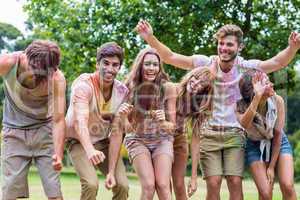 Happy friends covered in powder paint