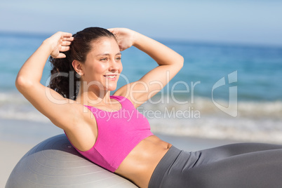 Fit woman stretching on exercise ball