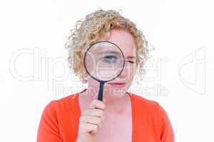 Pretty blonde looking at magnifying glass