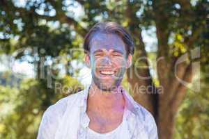 Happy man covered in powder paint