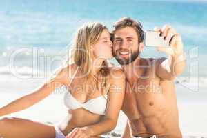 Happy couple taking selfie