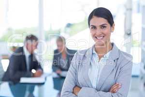 Beautiful businesswoman with arms crossed at office