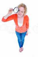 Pretty blonde looking at magnifying glass