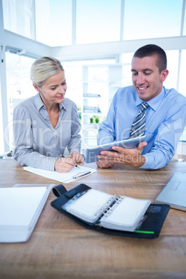 Business people using tablet in office