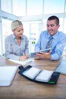 Business people using tablet in office