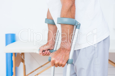Patient standing with crutch