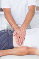 Physiotherapist doing back massage to his patient