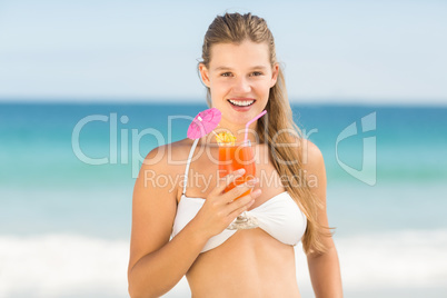 Happy pretty woman holding cocktail
