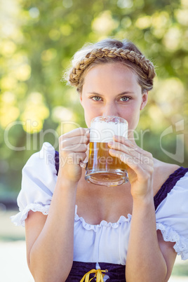 Pretty oktoberfest blonde drinking in the park