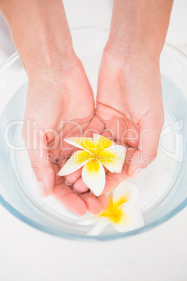 Woman enjoying a hand treatment in a bowl