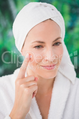 Close up of a beautiful young woman with cream