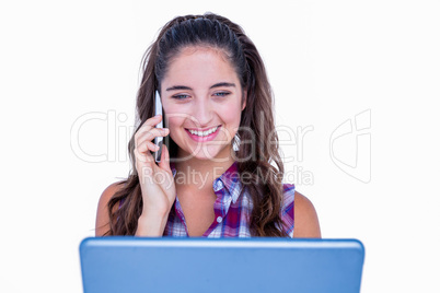 Happy pretty brunette using tablet computer and having phone cal