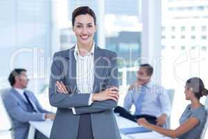 Beautiful businesswoman with arms crossed at office