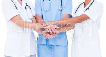 Doctors and nurse putting their hands together
