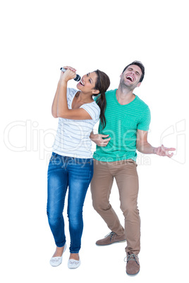 Friends singing in a microphone and playing air guitar